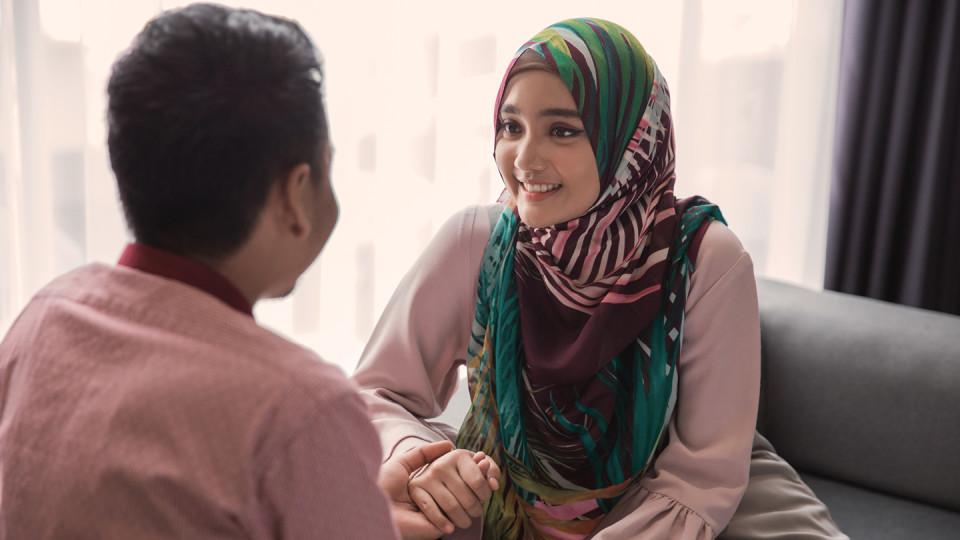 Couple holding hands talking 