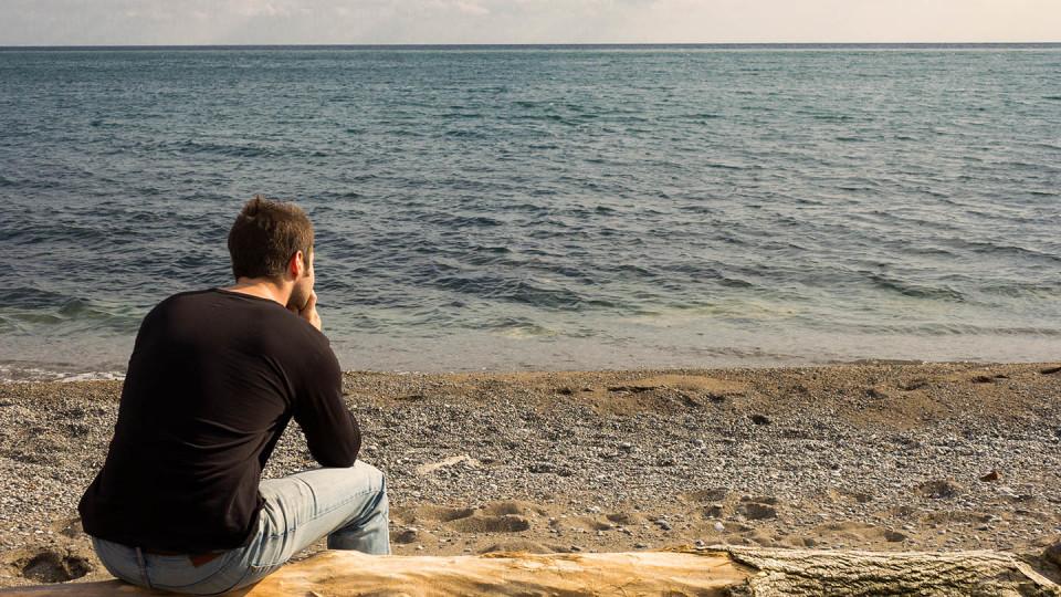 Man from behind on beach