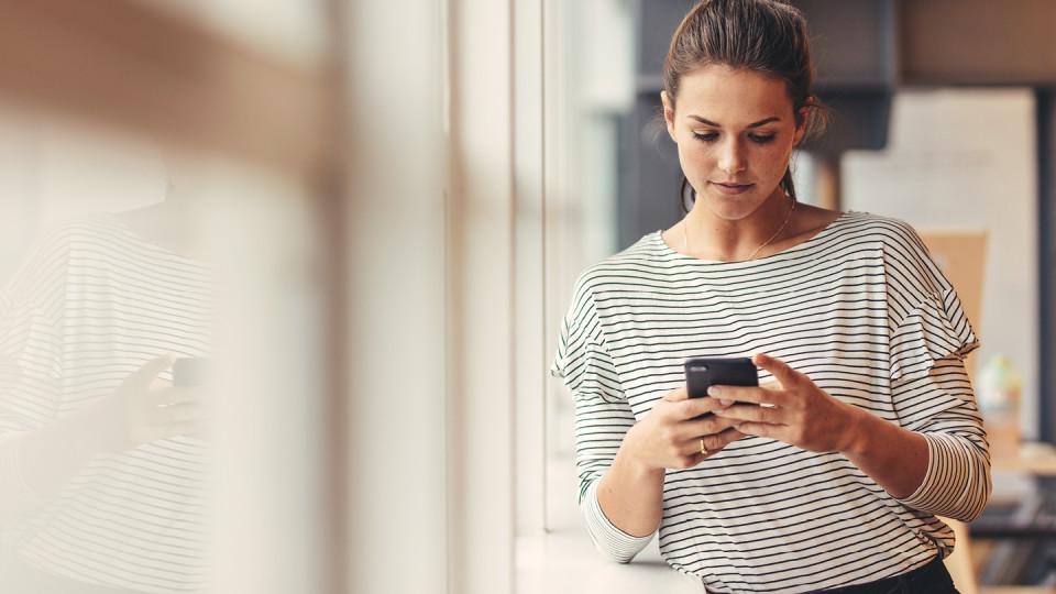 Woman in striped top texting 