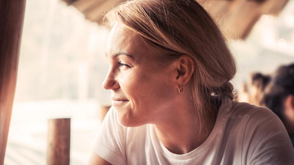 Blond woman looking out of window