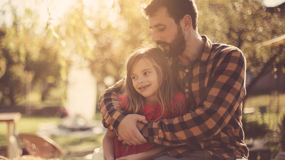 Dad hugging little girl