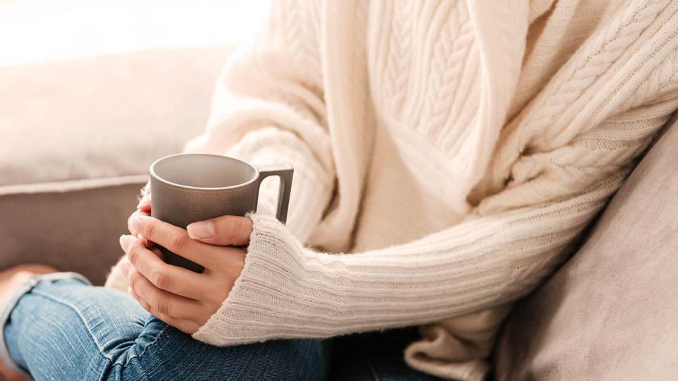 Newsroom - Drinking coffee on sofa 