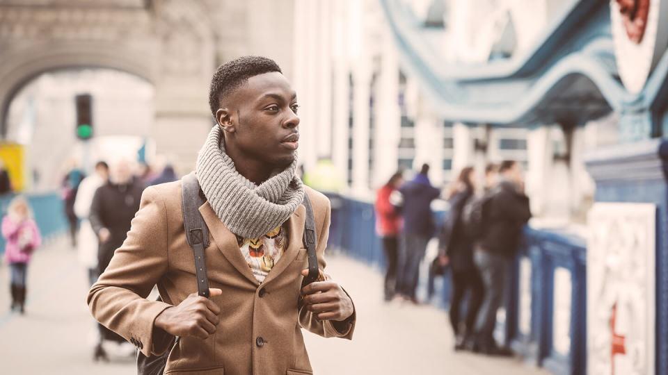 Man with rucksack walking in the city