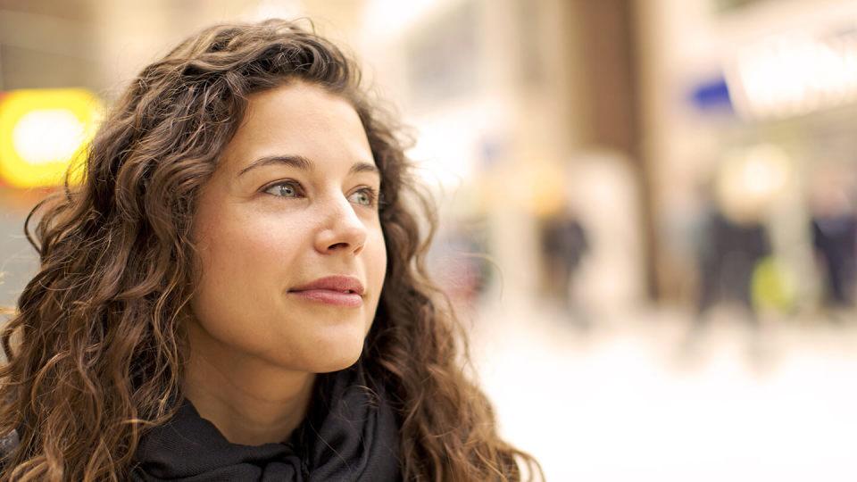 Woman wearing a scarf smiling