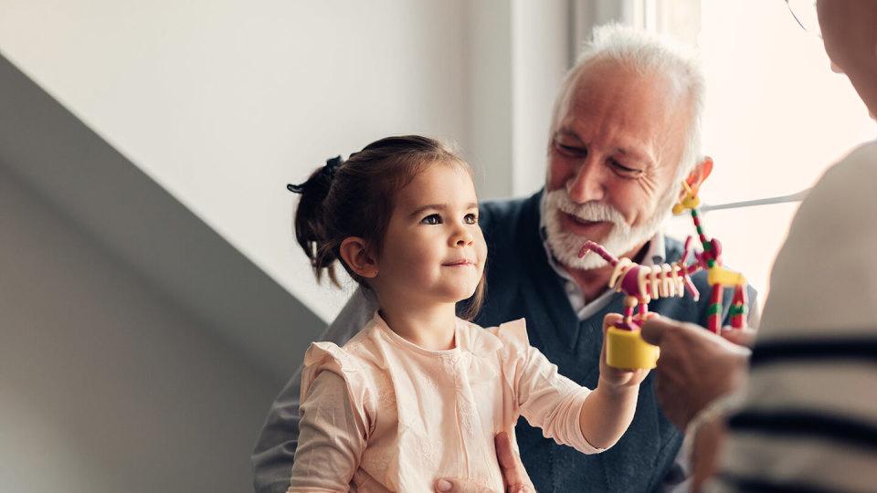 Young girl sat on grandparents knee