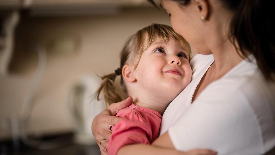 Little girl smiling at mum