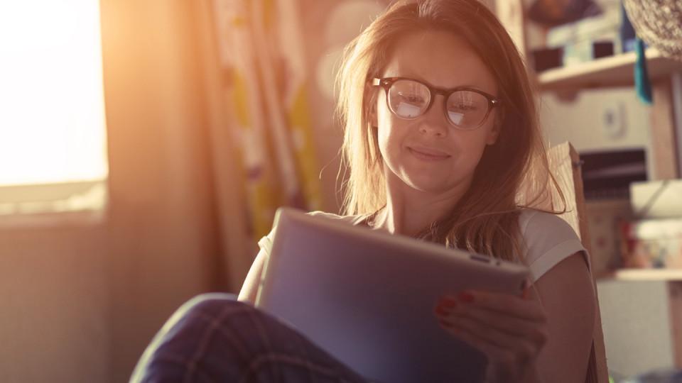 Woman in glasses looking at tablet