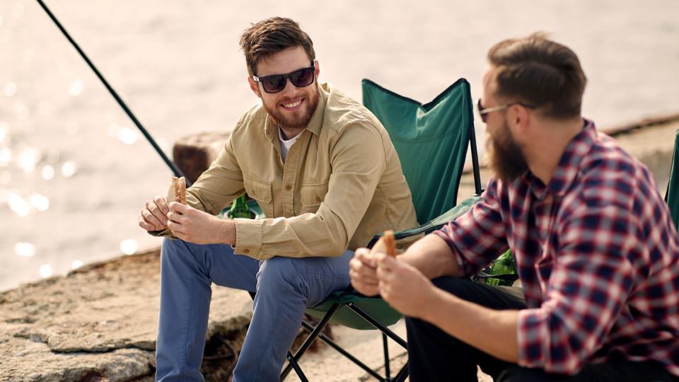 Men eating sandwiches and fishing