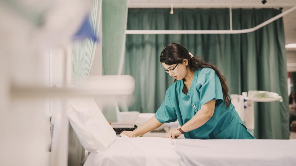 Nurse making the bed at a hospital