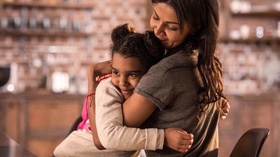 Mother and daughter hugging