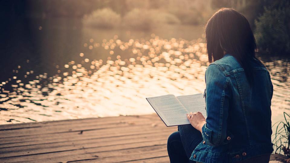 Newsroom Image - woman reading book by lake