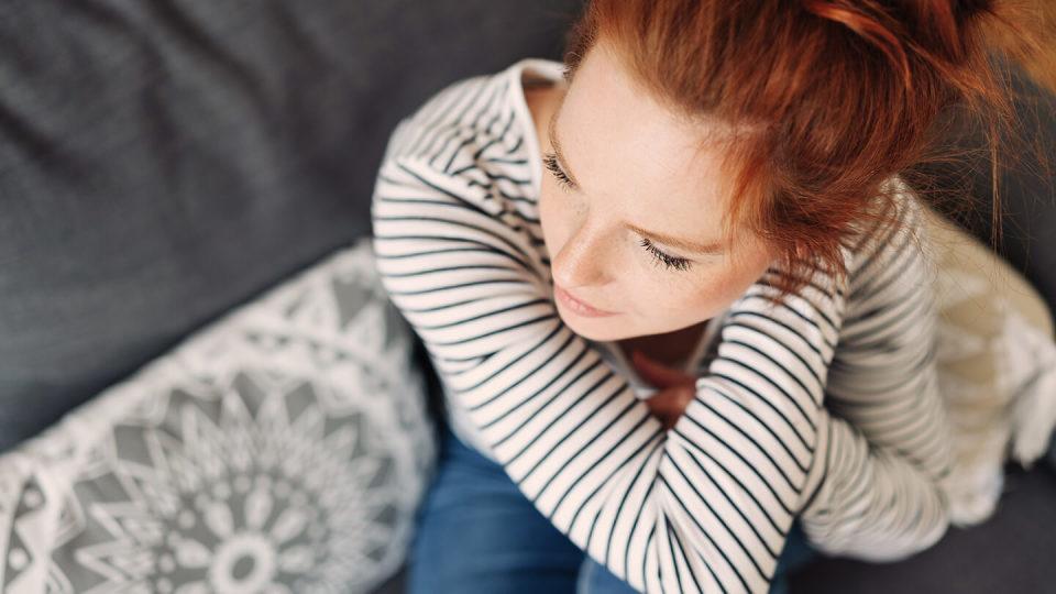 Young woman sat on the sofa