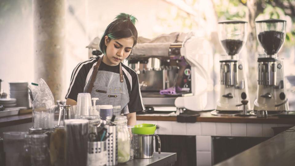 Female barista making coffee in a cafe