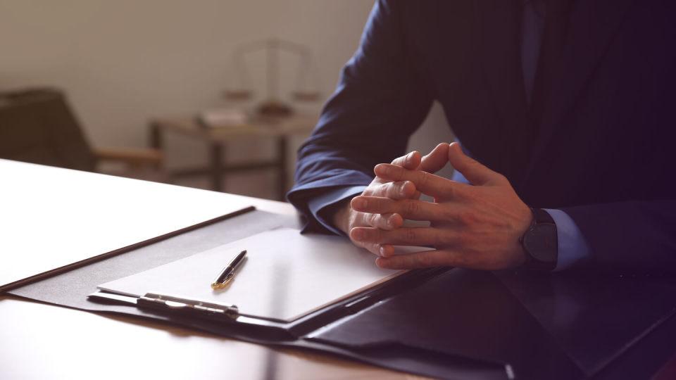 Newsroom - Man at table in an office