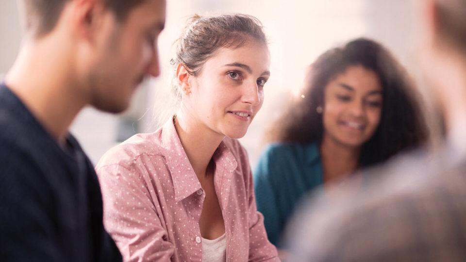 Group of students sat around a table