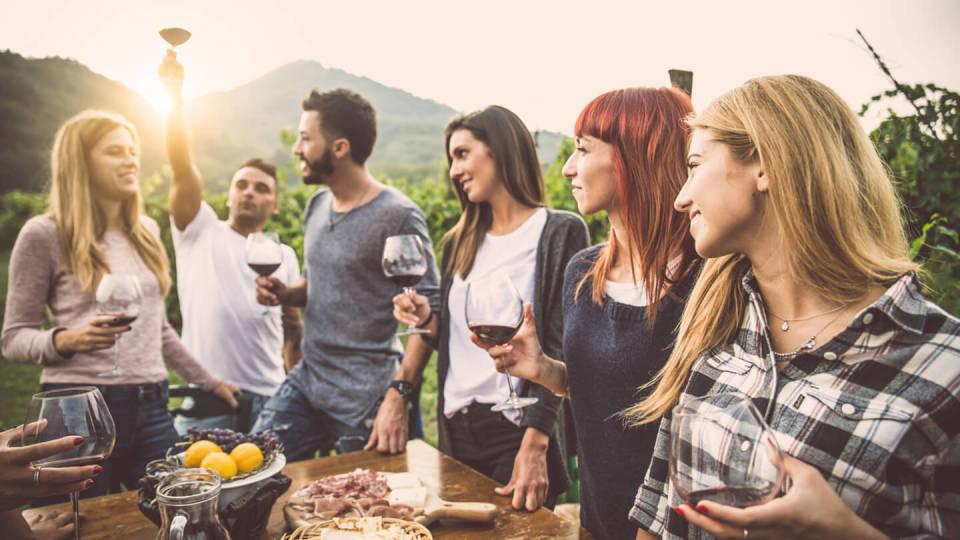 Happy group of teens having a meal in the open air