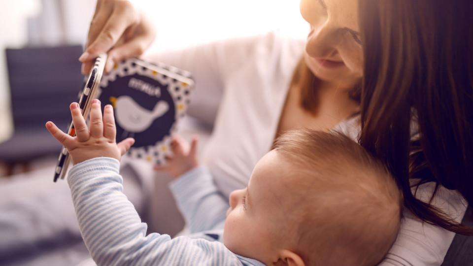 Woman with baby showing book