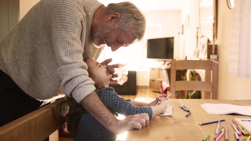 Granddaughter showing picture to her grandfather